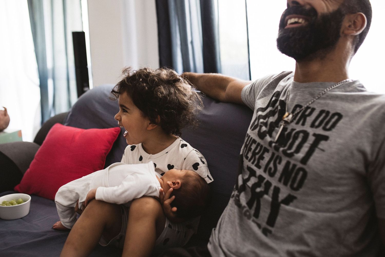 Candid black and white photographs showing emotional family interactions in a home setting.