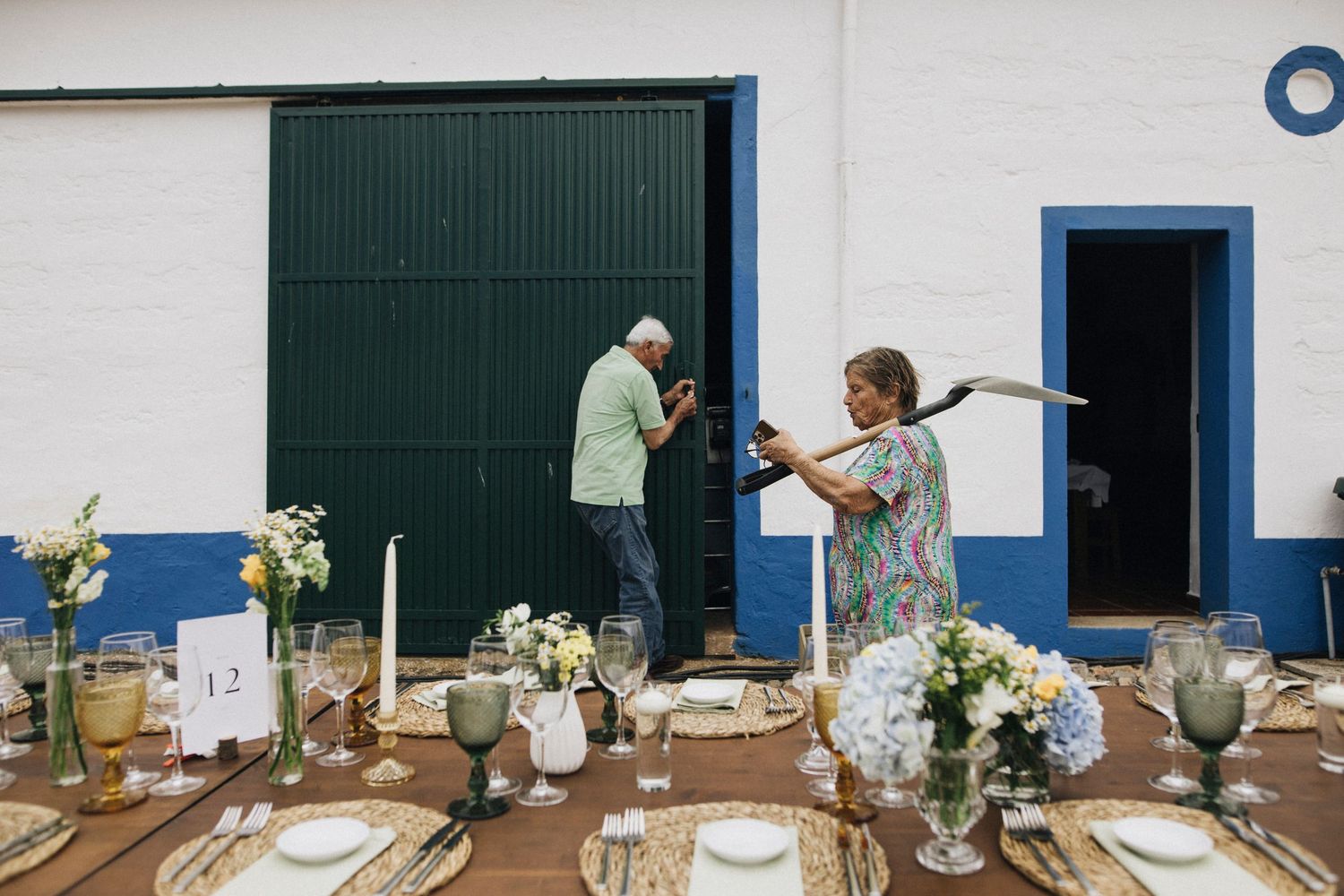 A collection of elegant floral arrangements and table settings displayed in a row against a white and blue wall.