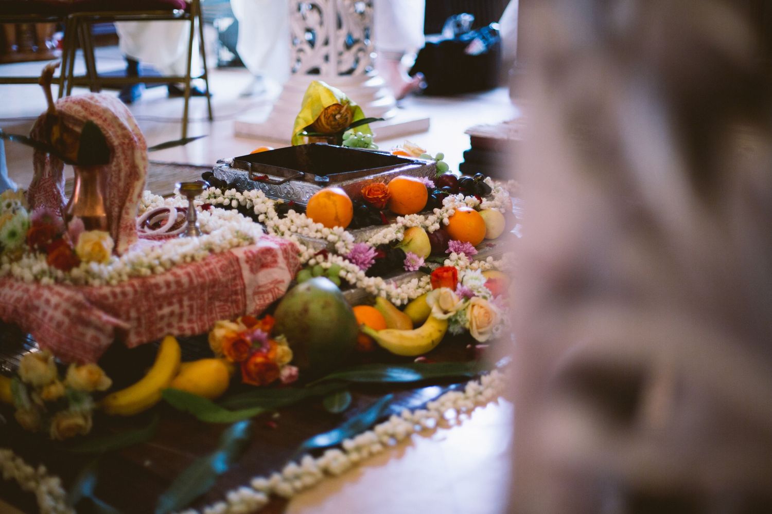 Autumn harvest table display with colorful gourds, pumpkins and seasonal decorations in warm natural lighting.