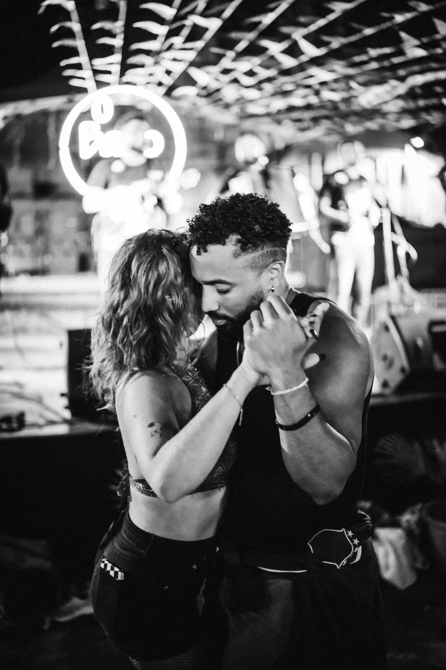 Black and white sequence of a romantic kiss in a dimly lit setting with dramatic lighting and shadows.