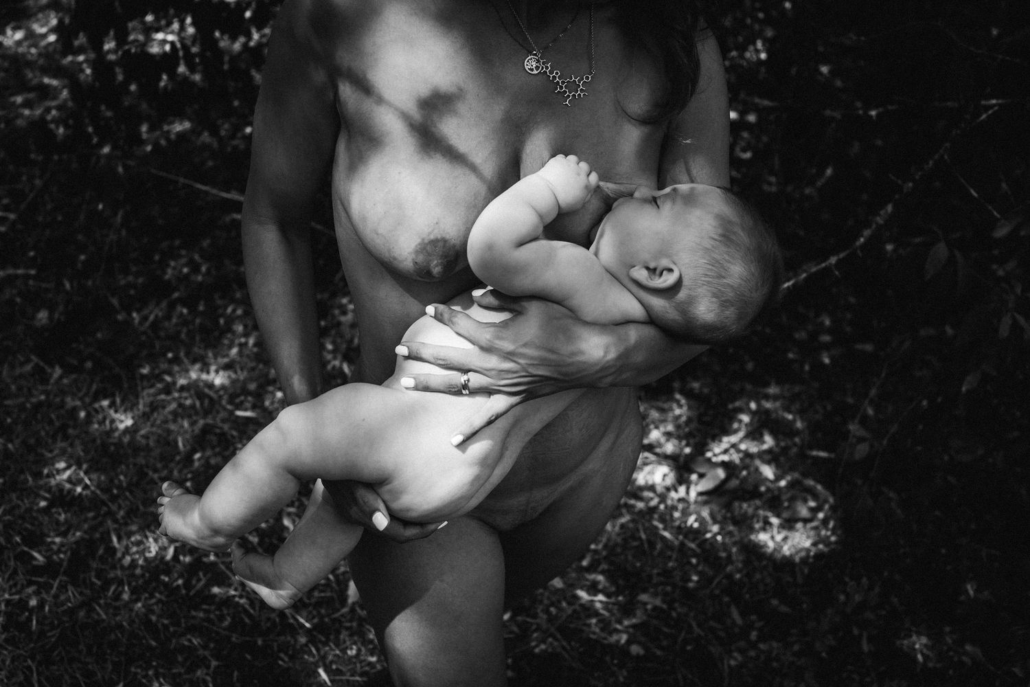 Intimate black and white portrait capturing loving connection between mother and baby.
