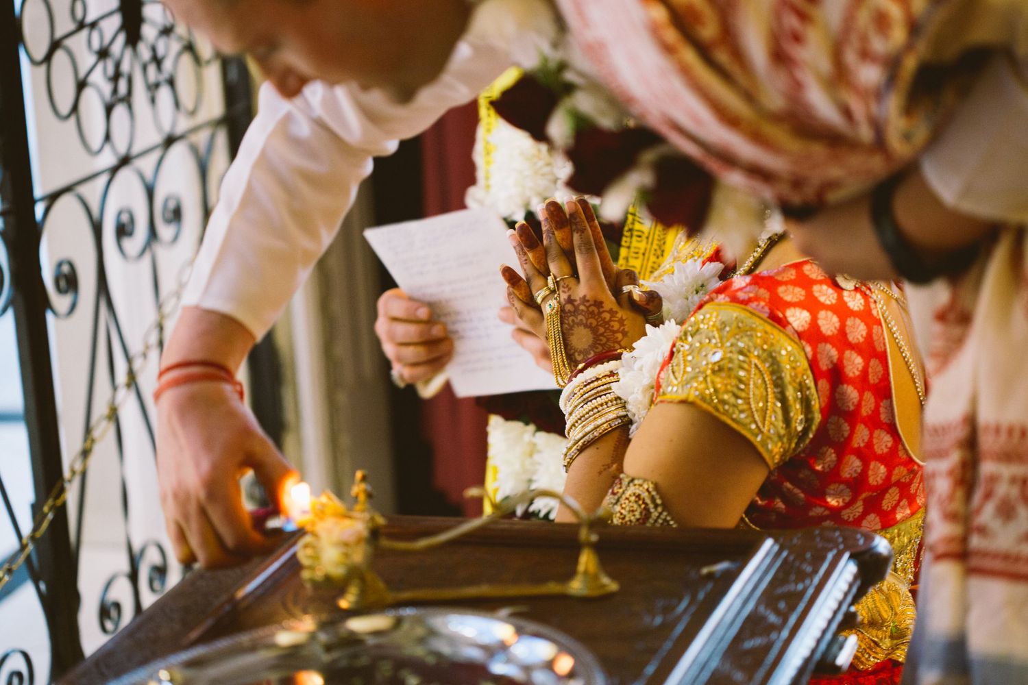 People in traditional Indian wedding attire dance and celebrate during a vibrant cultural ceremony.