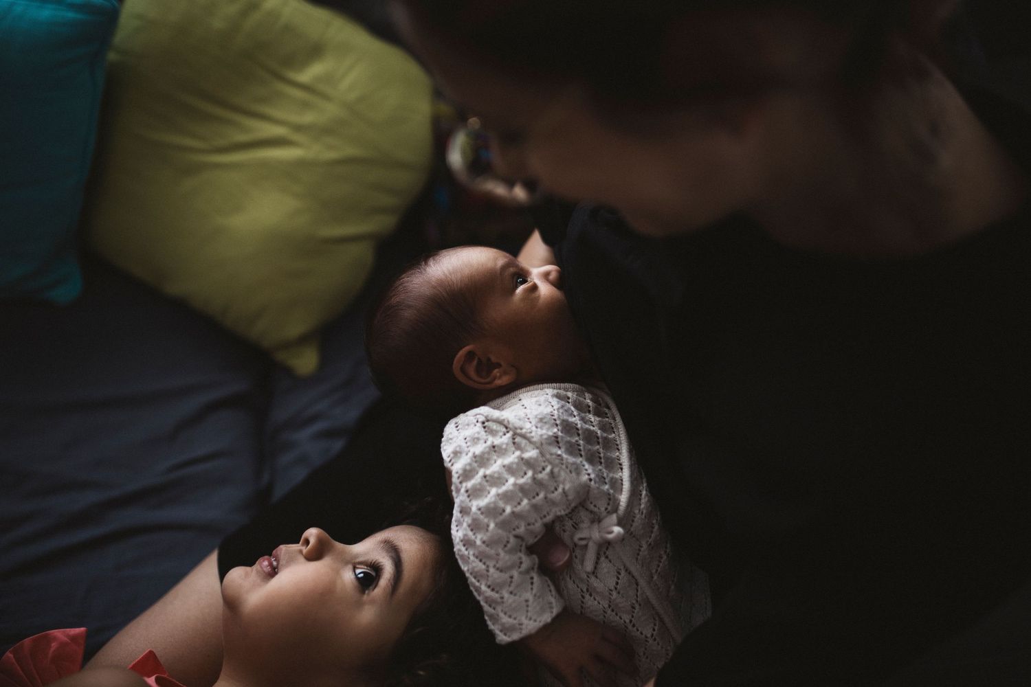 Intimate family photographs showing tender moments against dark backgrounds.