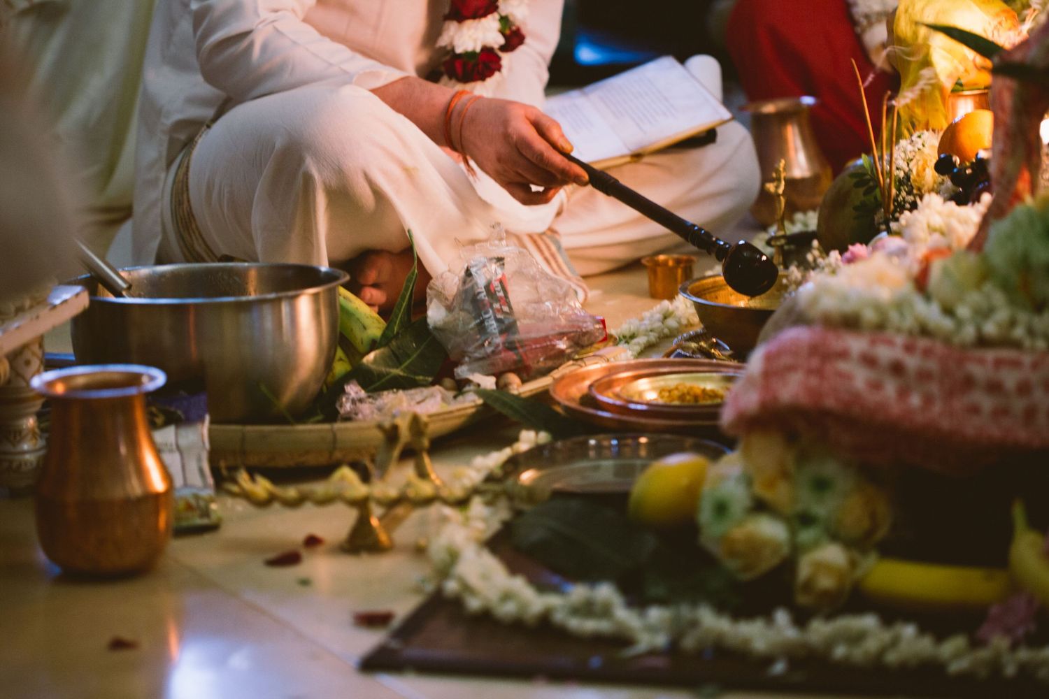 Close-up shots of hands preparing and serving food at an intimate dinner gathering with warm lighting.