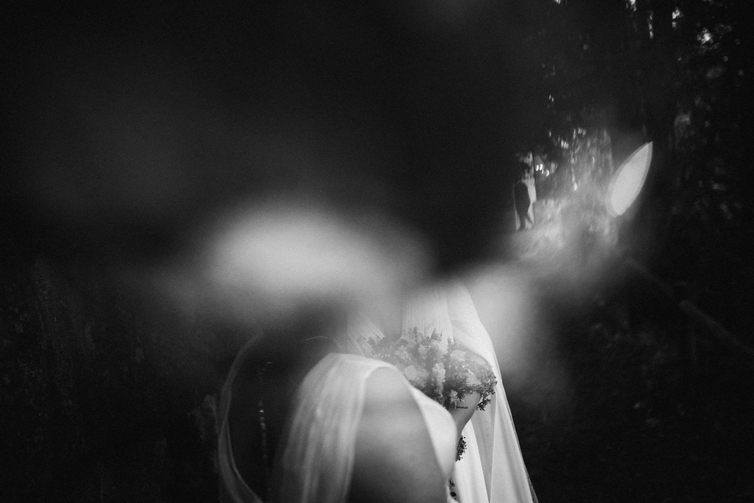 Abstract black and white wedding photography with dramatic lighting and bokeh effects.