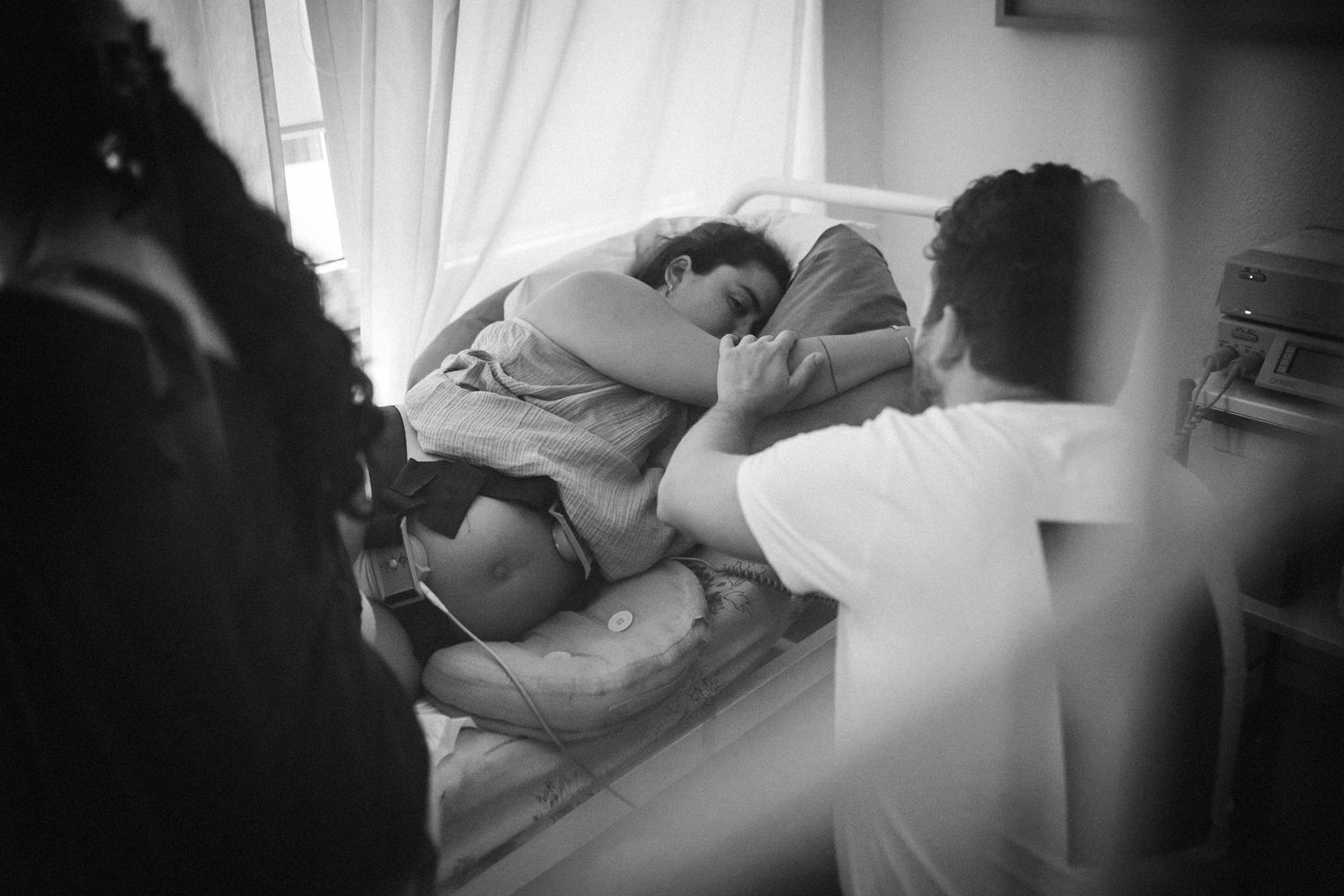 A black and white photo montage shows intimate moments of a couple cuddling and embracing in bed.