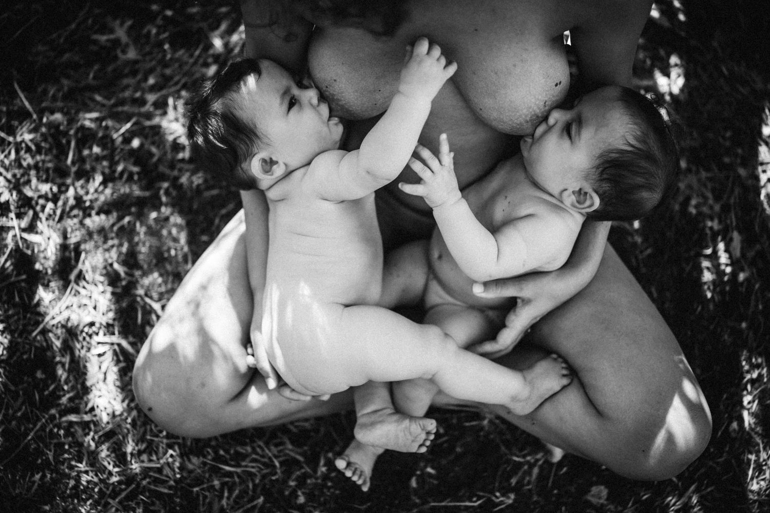 Candid outdoor portrait capturing tender bonding moment between mother and baby.