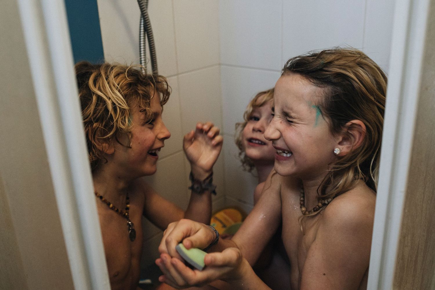 People sharing intimate conversations and moments in a bathroom setting.