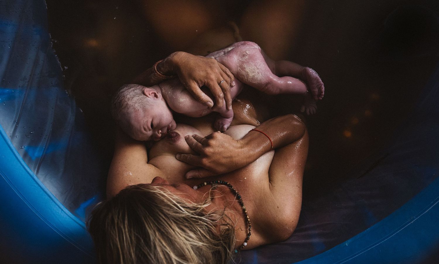 Romantic couple sharing intimate kisses in a dimly lit setting with dramatic lighting and shadows.