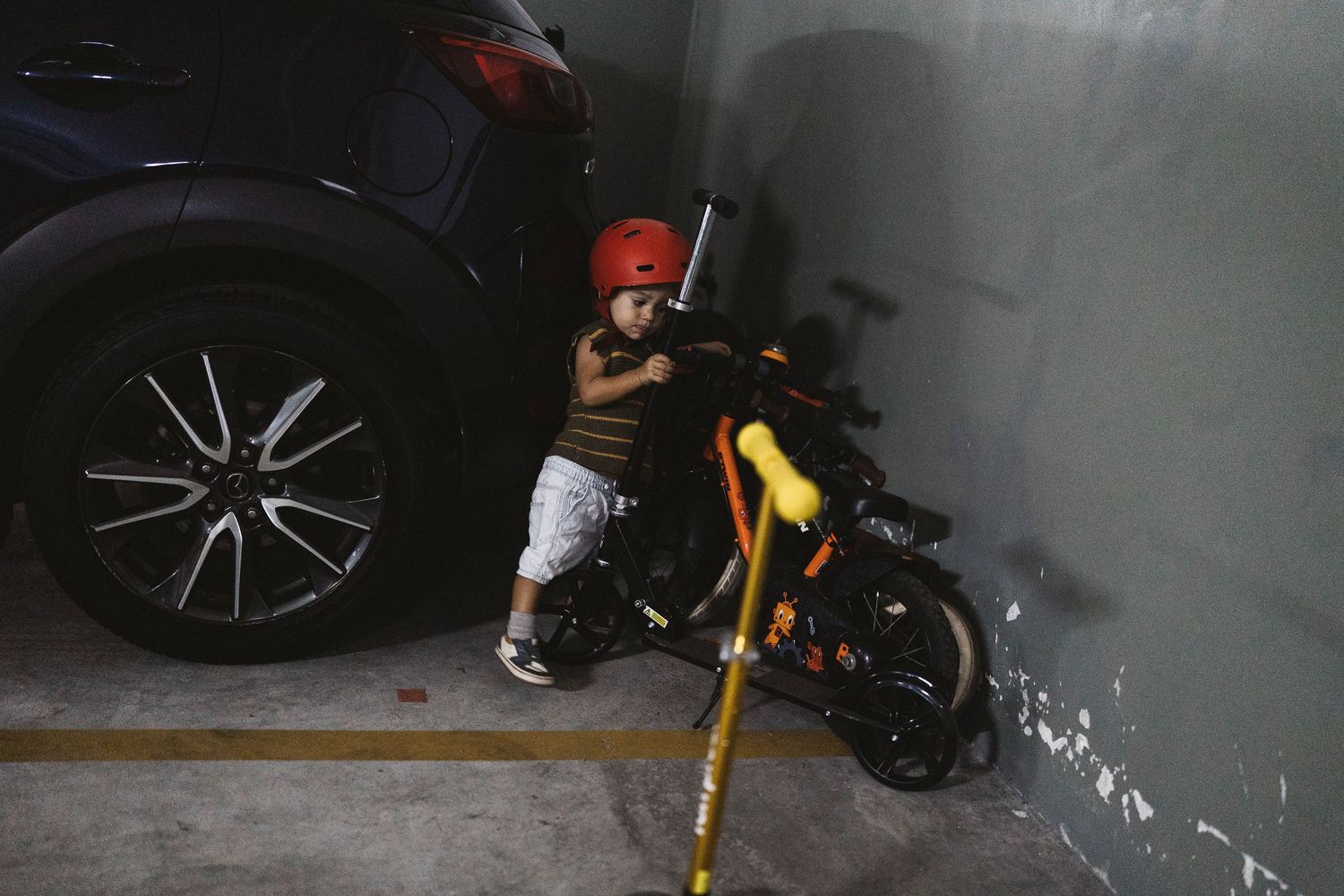 A series of connected images showing a bicycle being assembled with tools and parts laid out on a dark floor.