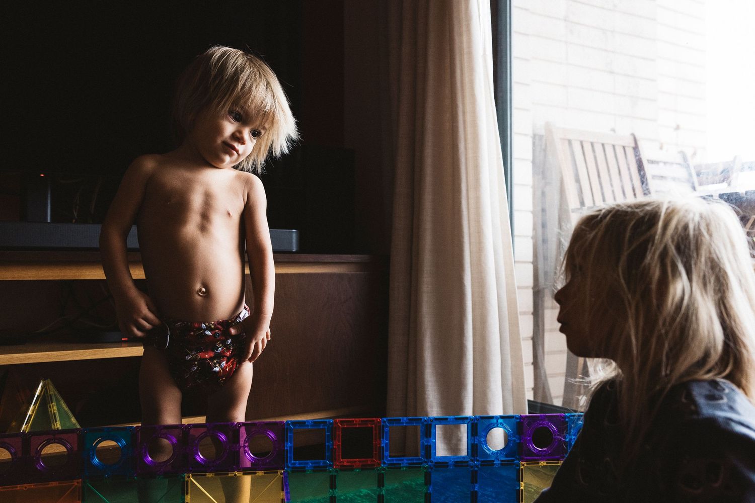 Soft natural window light illuminates a quiet indoor domestic scene.