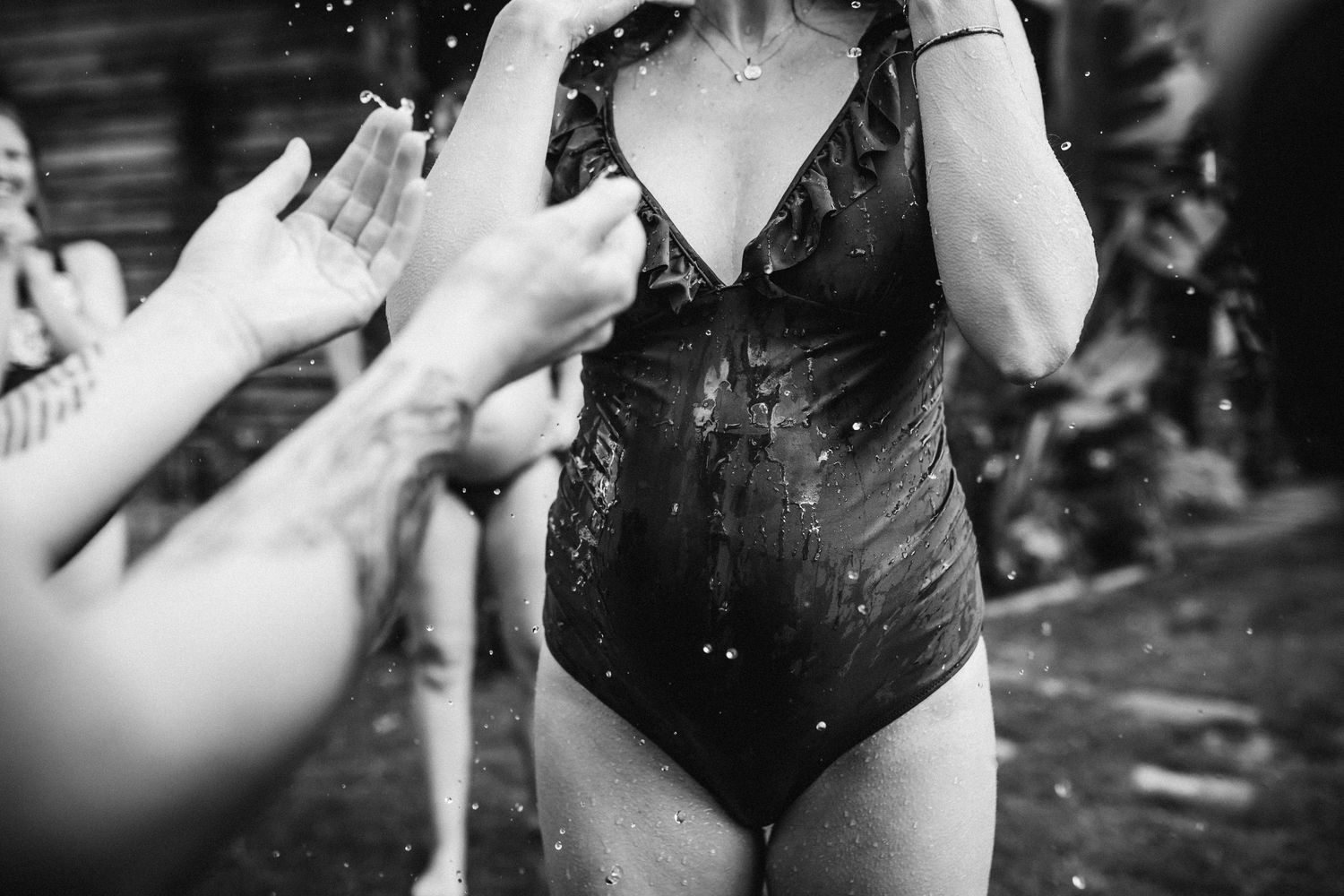 Water splashing and droplets flying in dramatic black and white close-up photography.