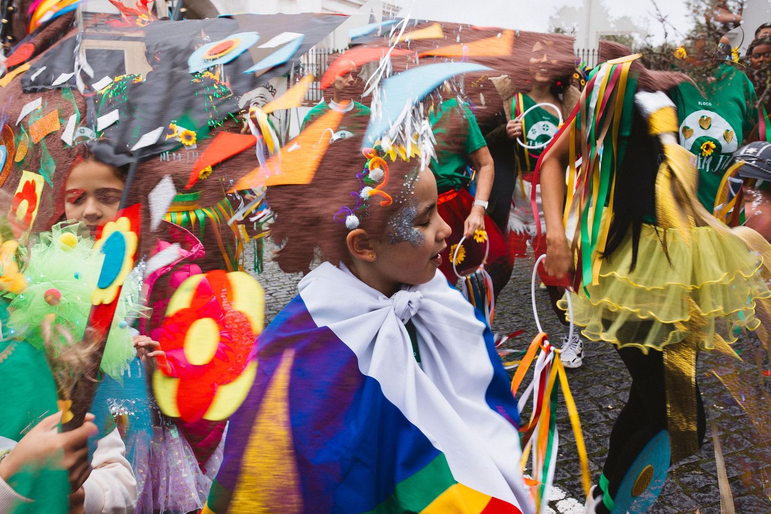 Colorfully dressed carnival dancers celebrate in vibrant costumes during a festive street parade.