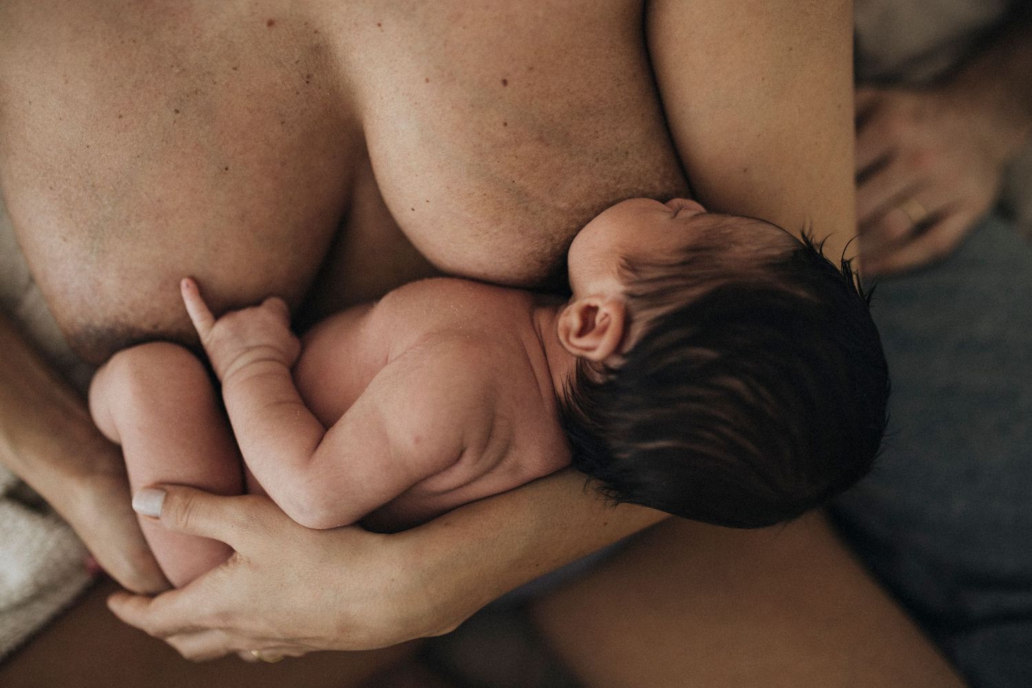 Close-up photography showing gentle touch and care in muted tones.