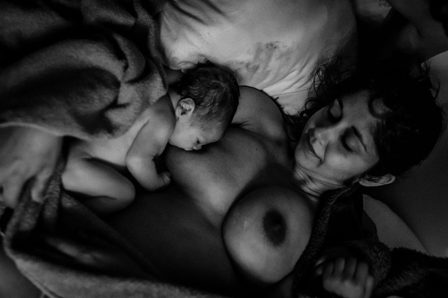 Intimate black and white photograph documenting a birth experience.