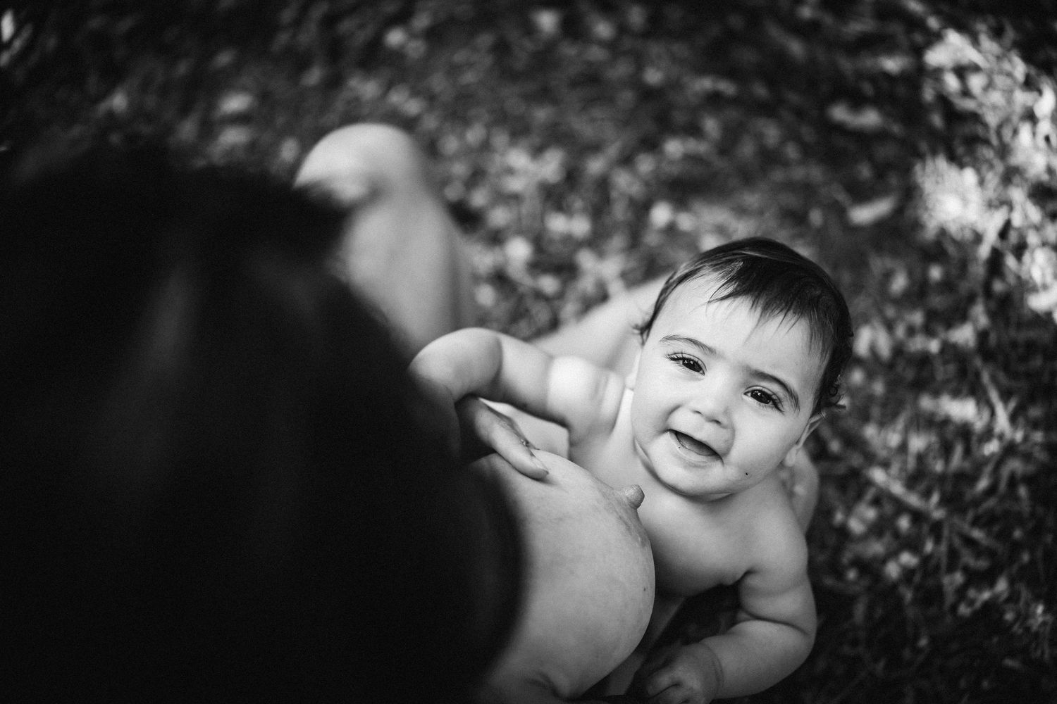 A series of black and white portraits showing joyful expressions and genuine emotions in natural lighting.