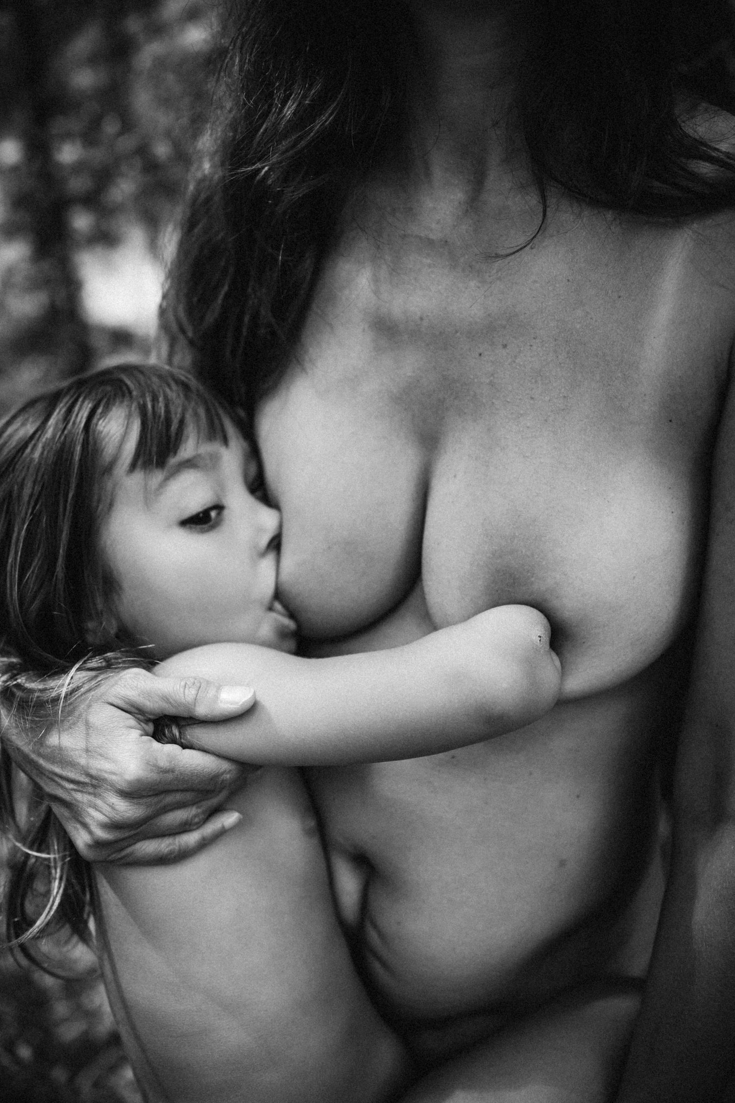 Intimate black and white close-up portrait showing tender affection and connection between parent and child.