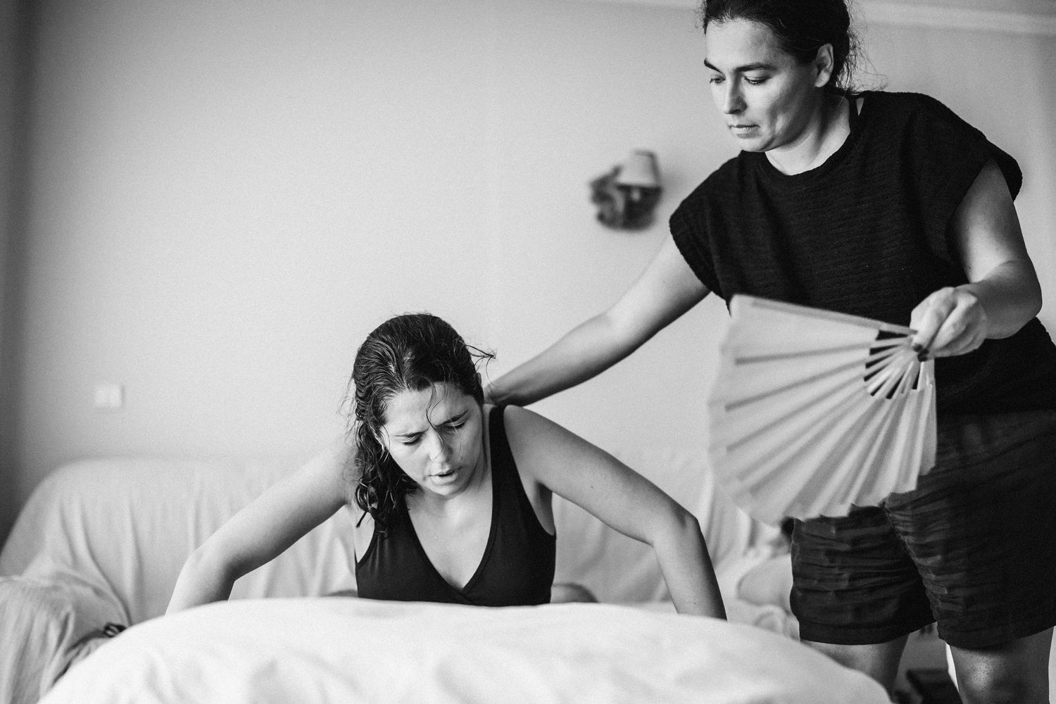 Black and white series showing quiet moments in a bright interior space.