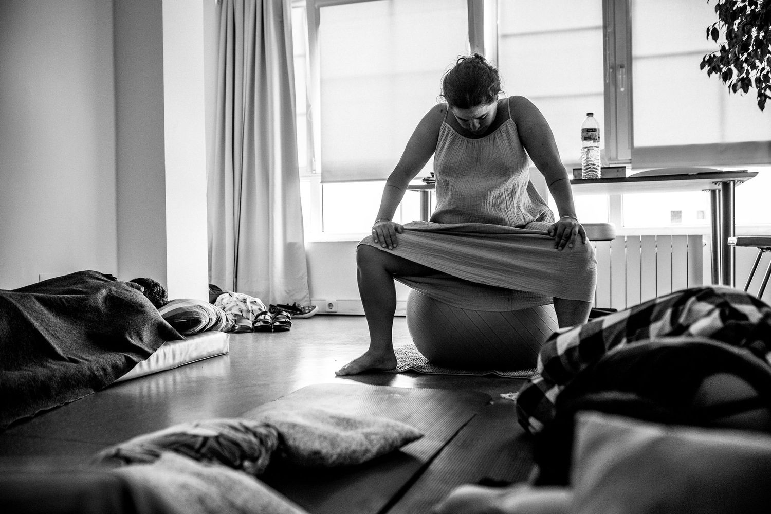 A sequence of black and white photographs showing a person receiving a therapeutic massage on a table.