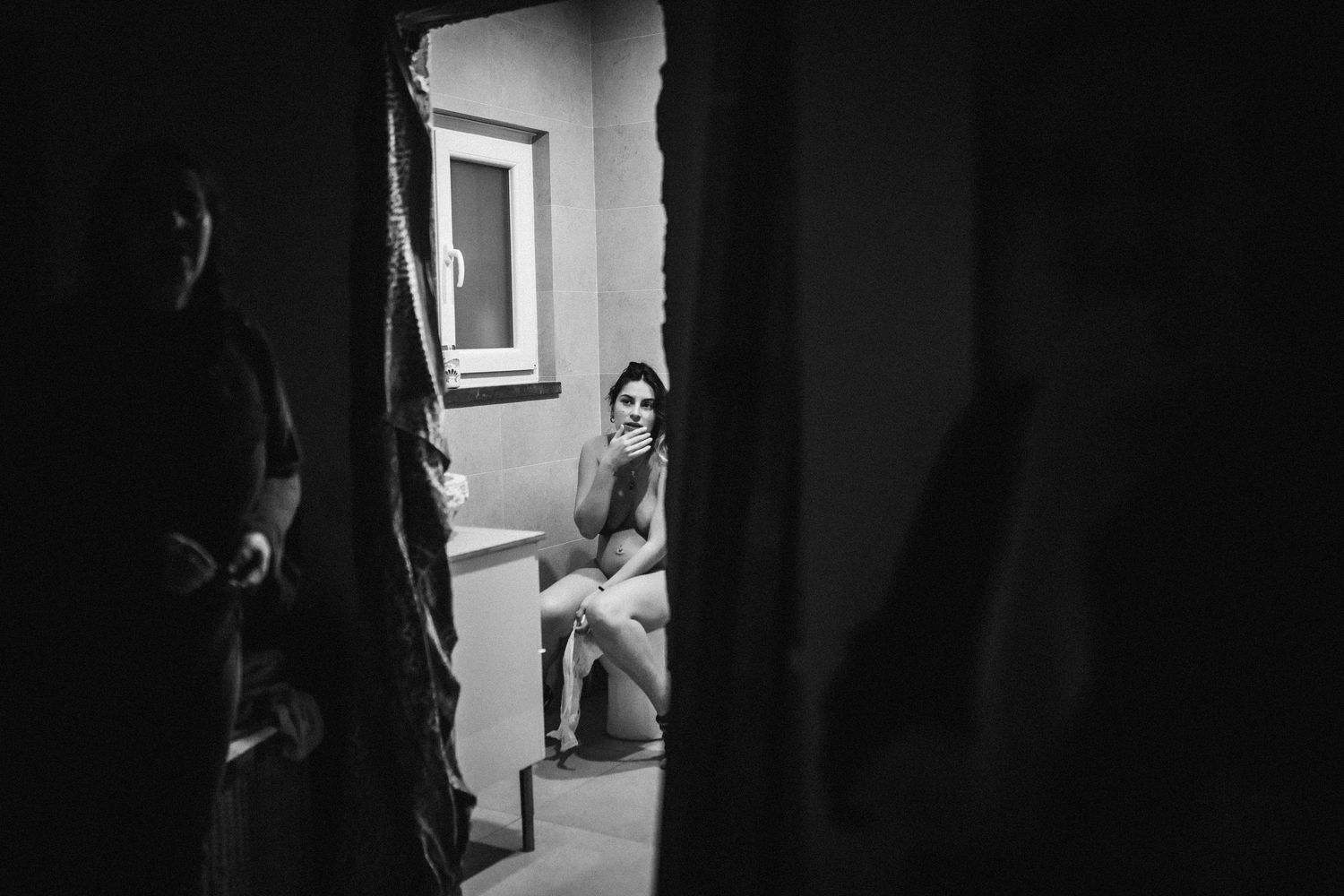 Emotional black and white photograph showing support during a birthing experience.