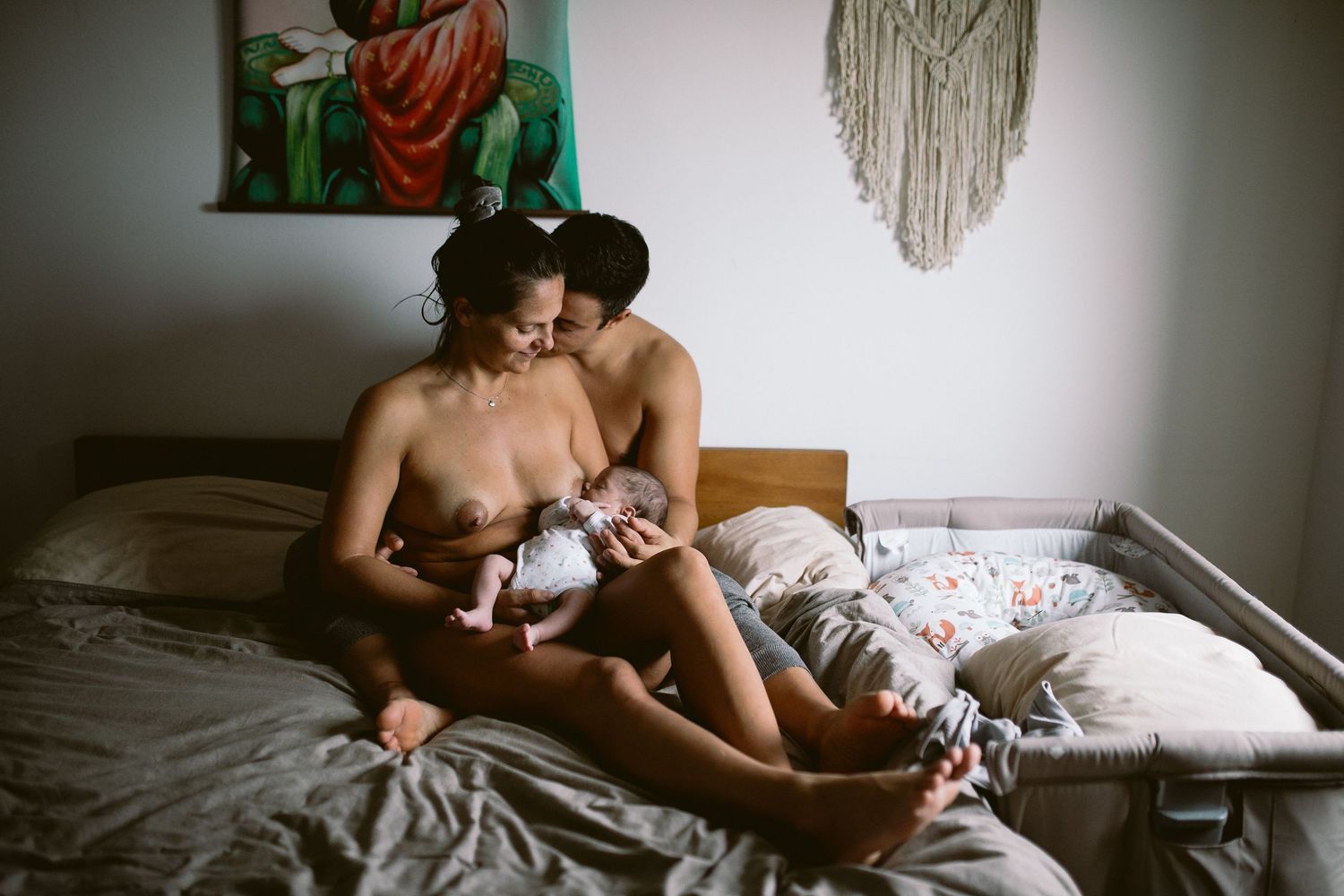 Intimate black and white lifestyle photography session capturing tender moments in bed.