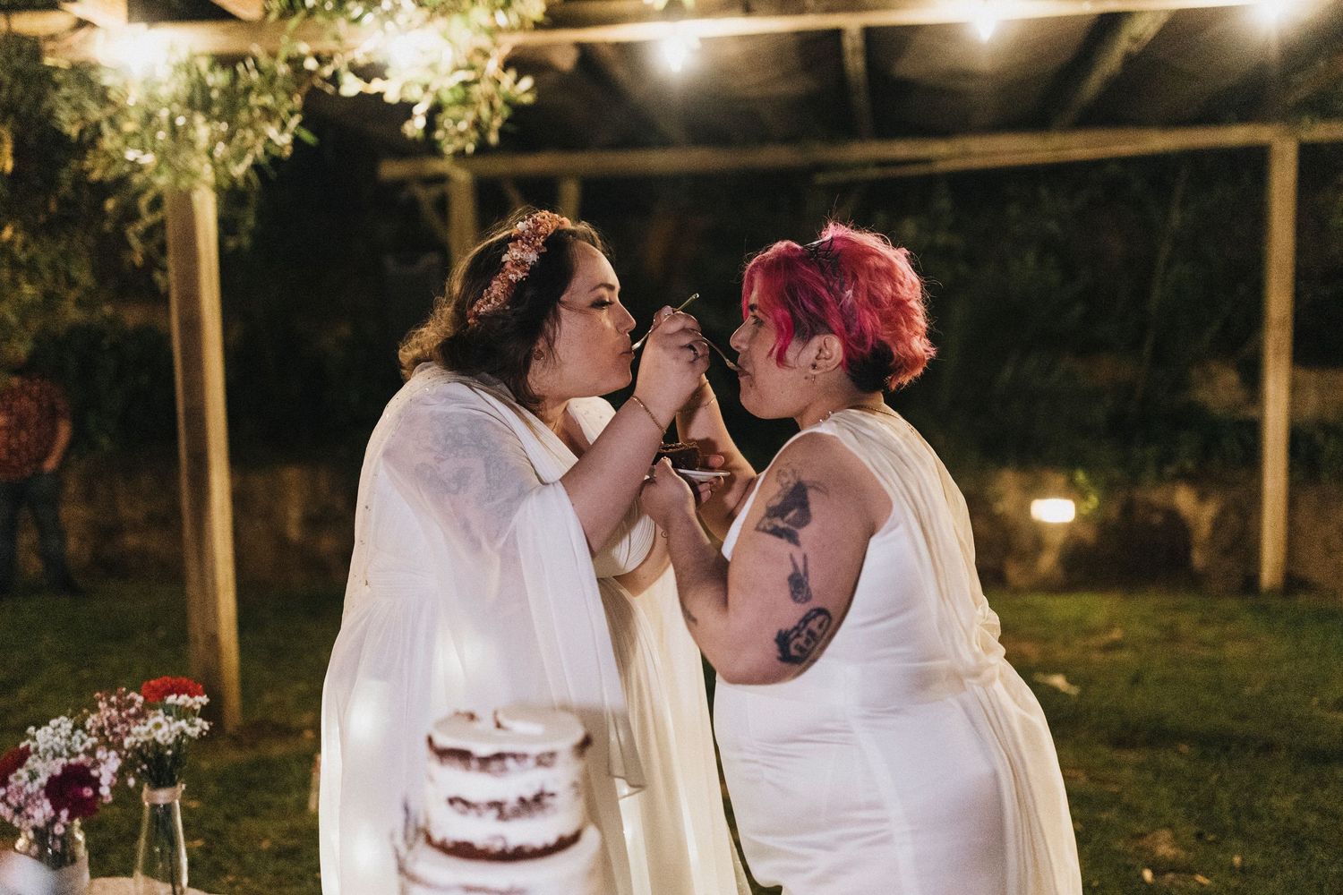 Outdoor evening celebration with string lights illuminating the festivities.
