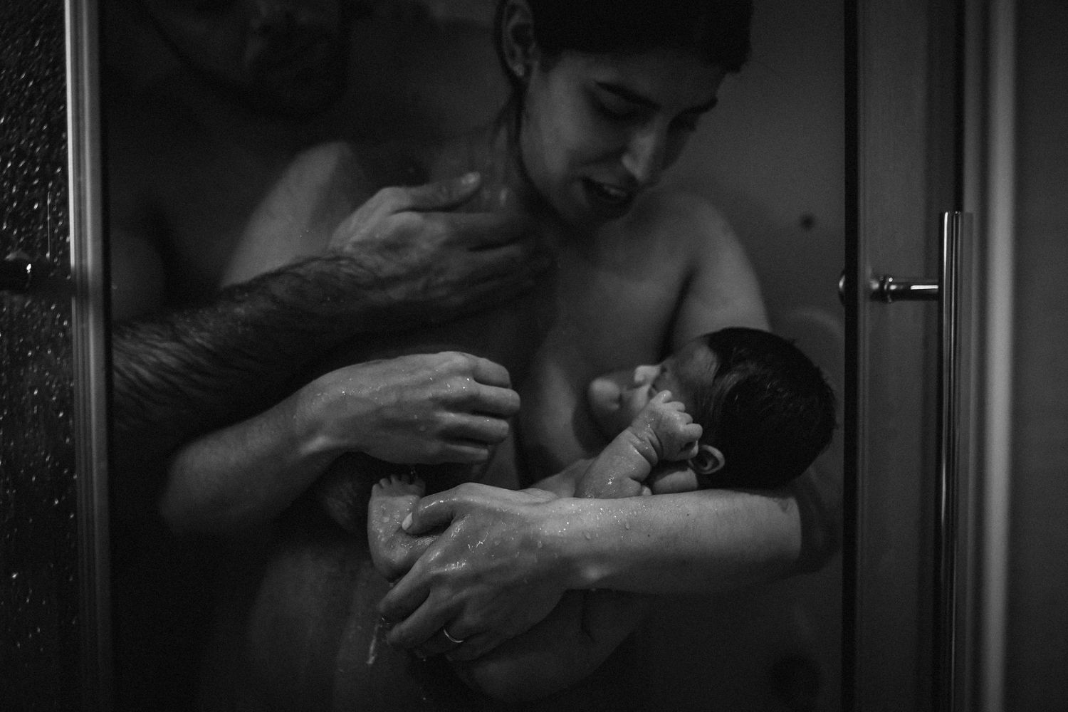 Dramatic black and white photography showing intimate nurturing moments.