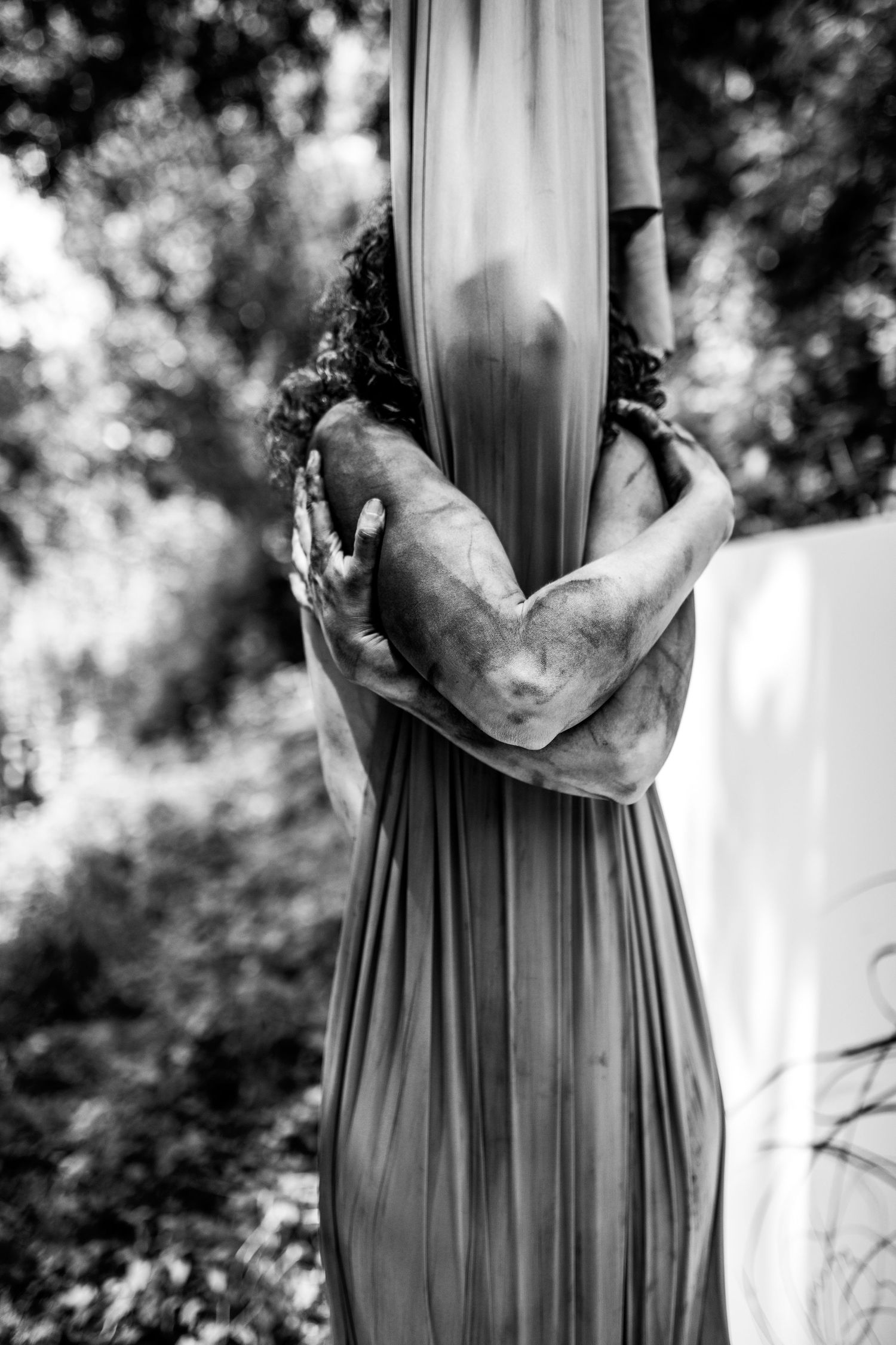 Black and white portrait series featuring flowing dress fabric and elegant poses.