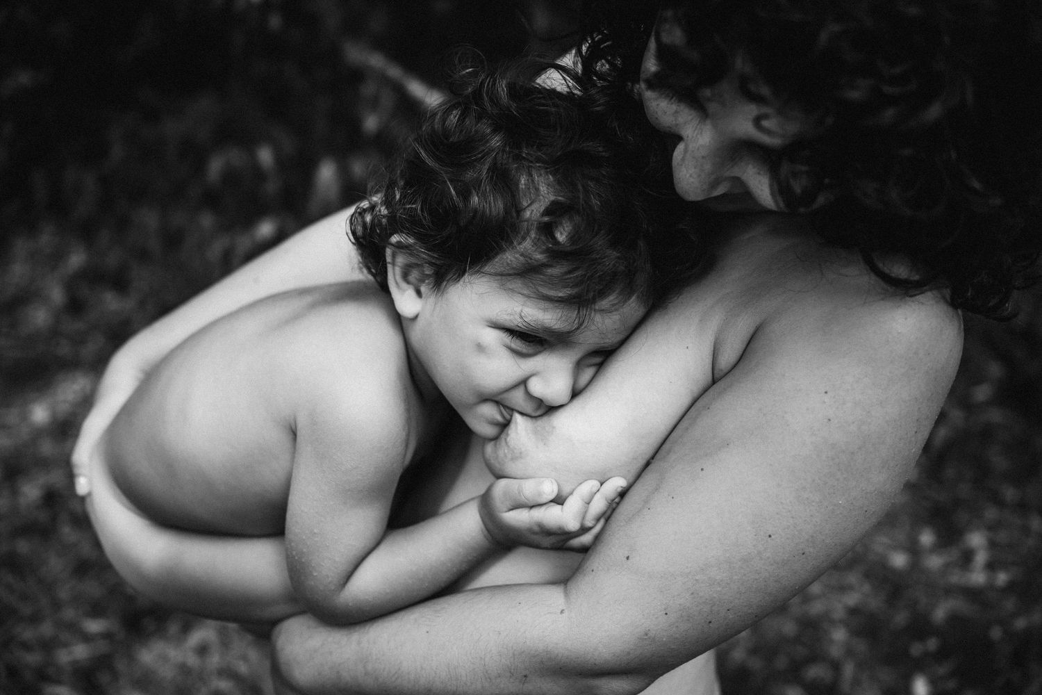 Gentle black and white portrait of nurturing moment between mother and baby.