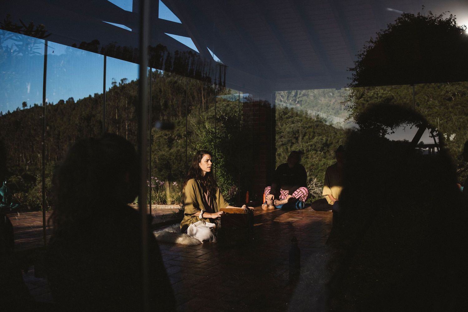 Dark outdoor scene with natural lighting and silhouettes in the distance.