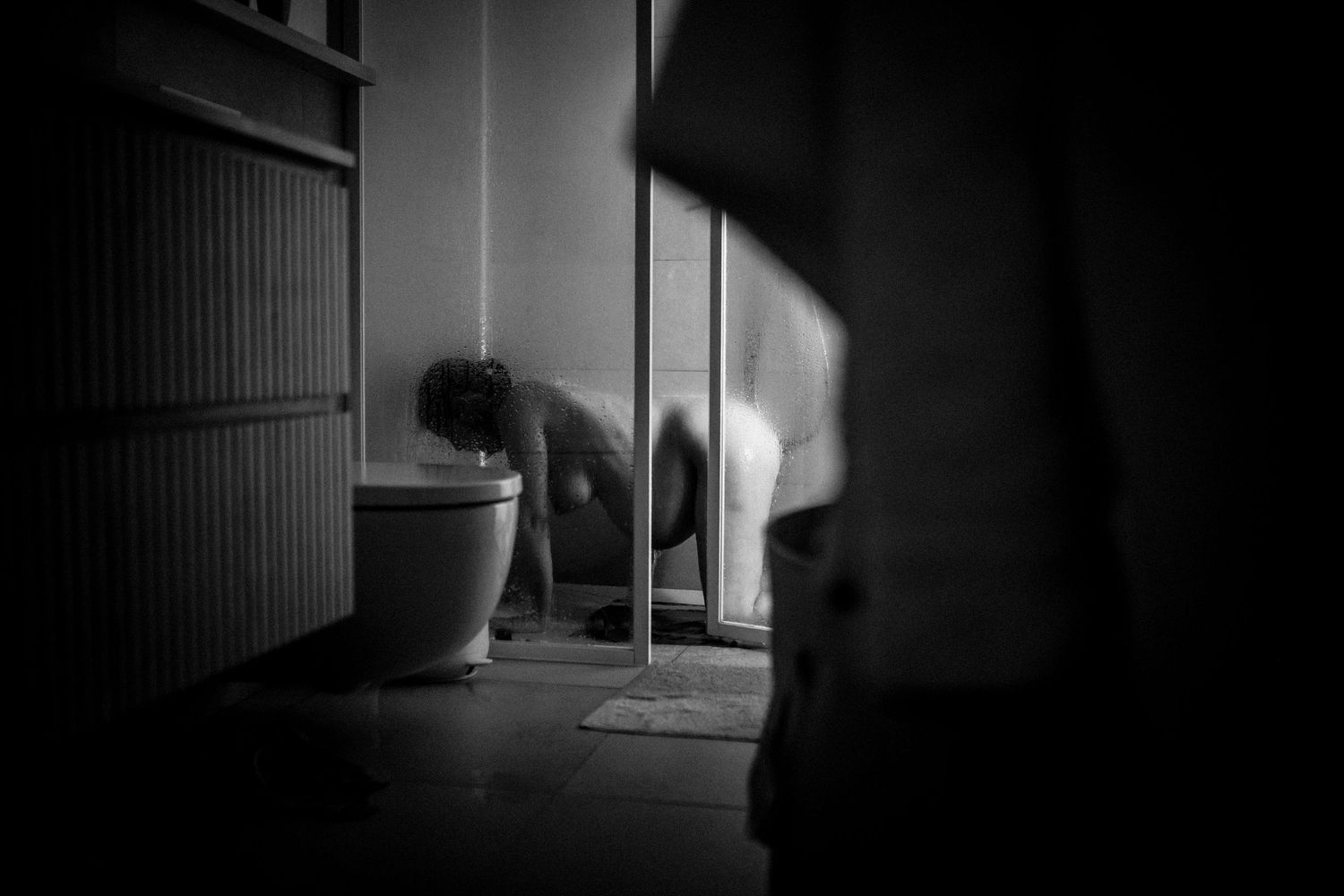 A series of dark moody black and white architectural photographs showing empty corridors and hallways.