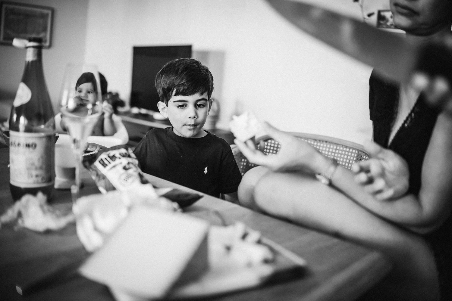Children engaged in arts and crafts activities at a table with various supplies and materials.