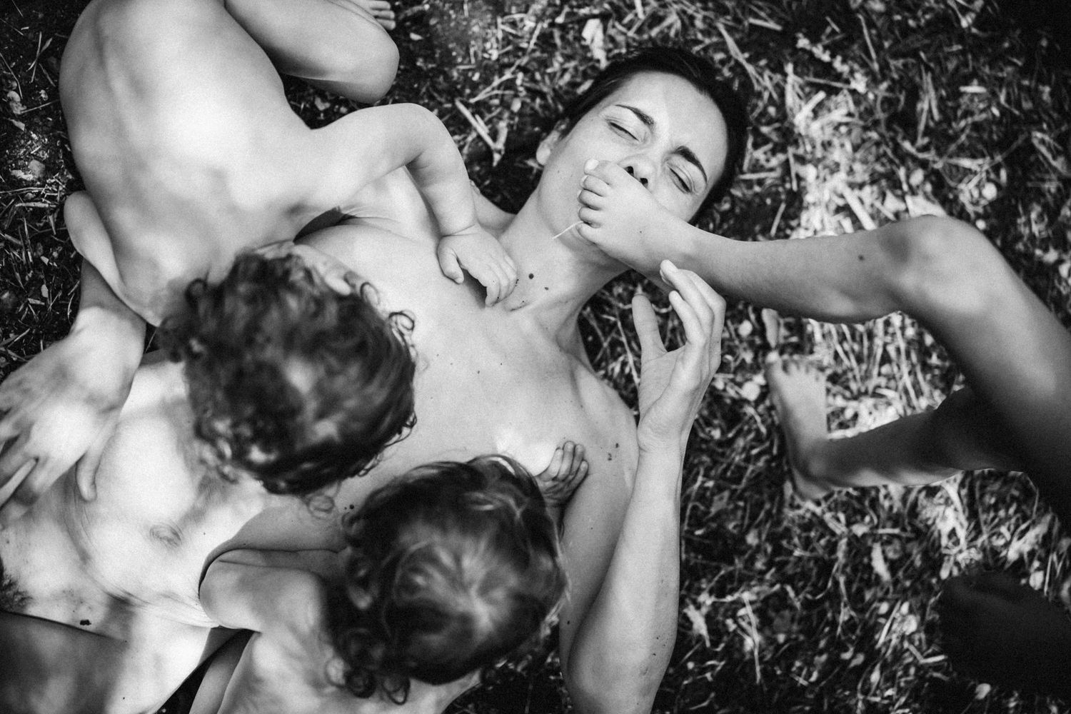 Artistic breastfeeding portrait capturing tender maternal bonding moment in monochrome.