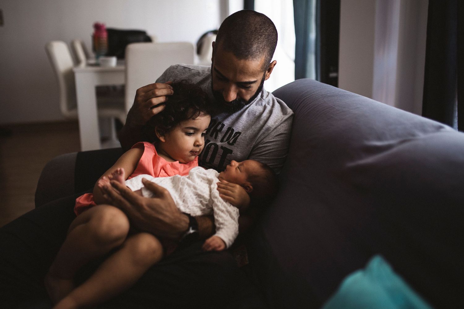 A tender family moment captured in natural light through a series of intimate indoor photographs.