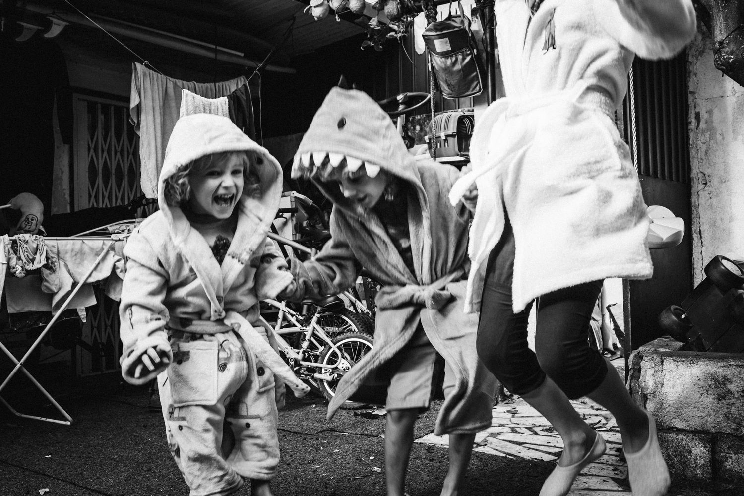 Black and white sequence showing playful moments and interactions indoors.