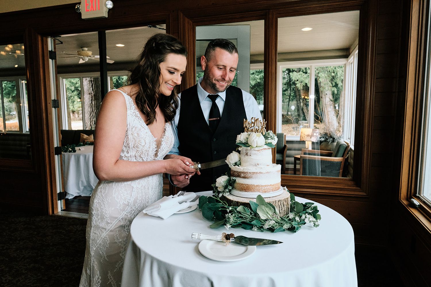 Happy wedding couple cutting cake - Door County Wisconsin Wedding Photography