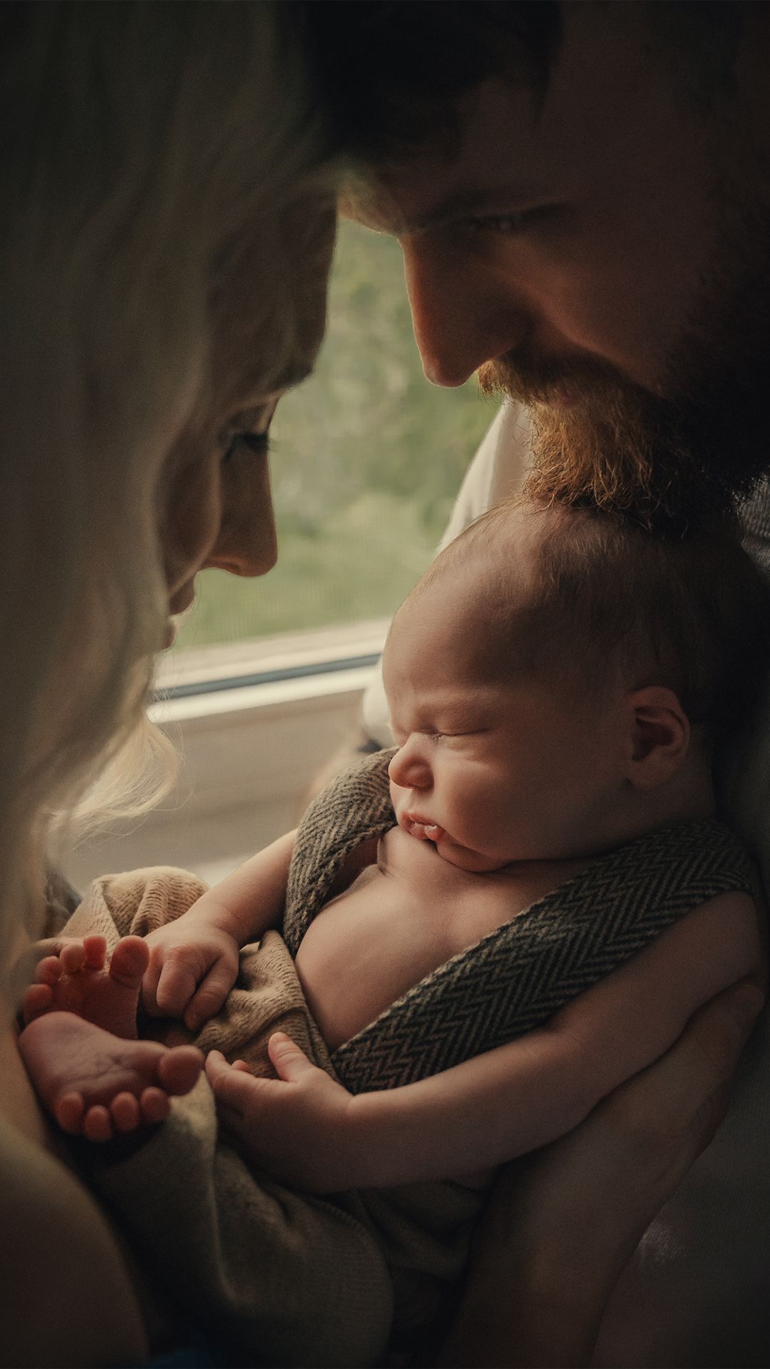 A sleeping baby rests peacefully in a car seat during a journey.