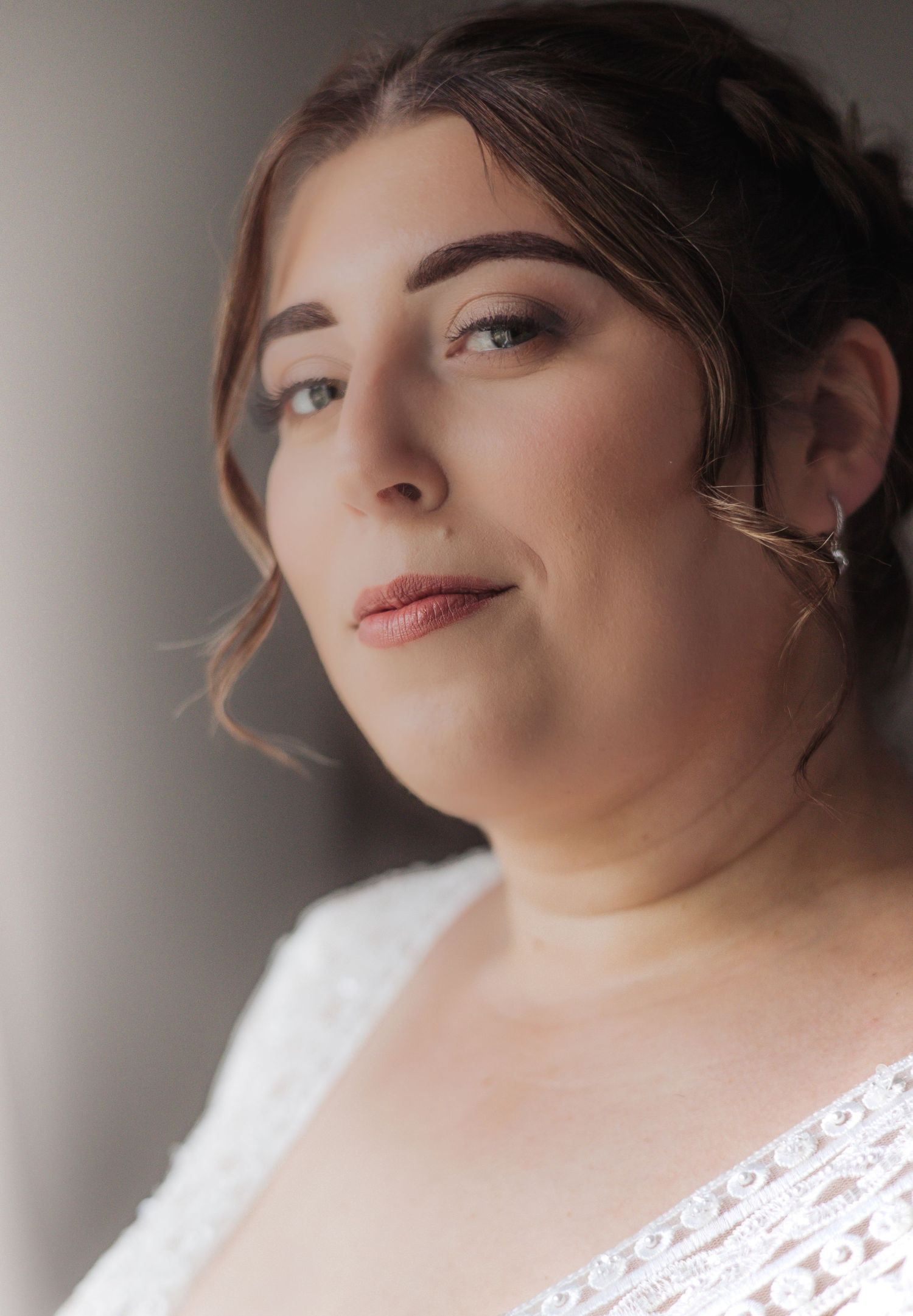 Close-up portrait with delicate makeup and white lace details.