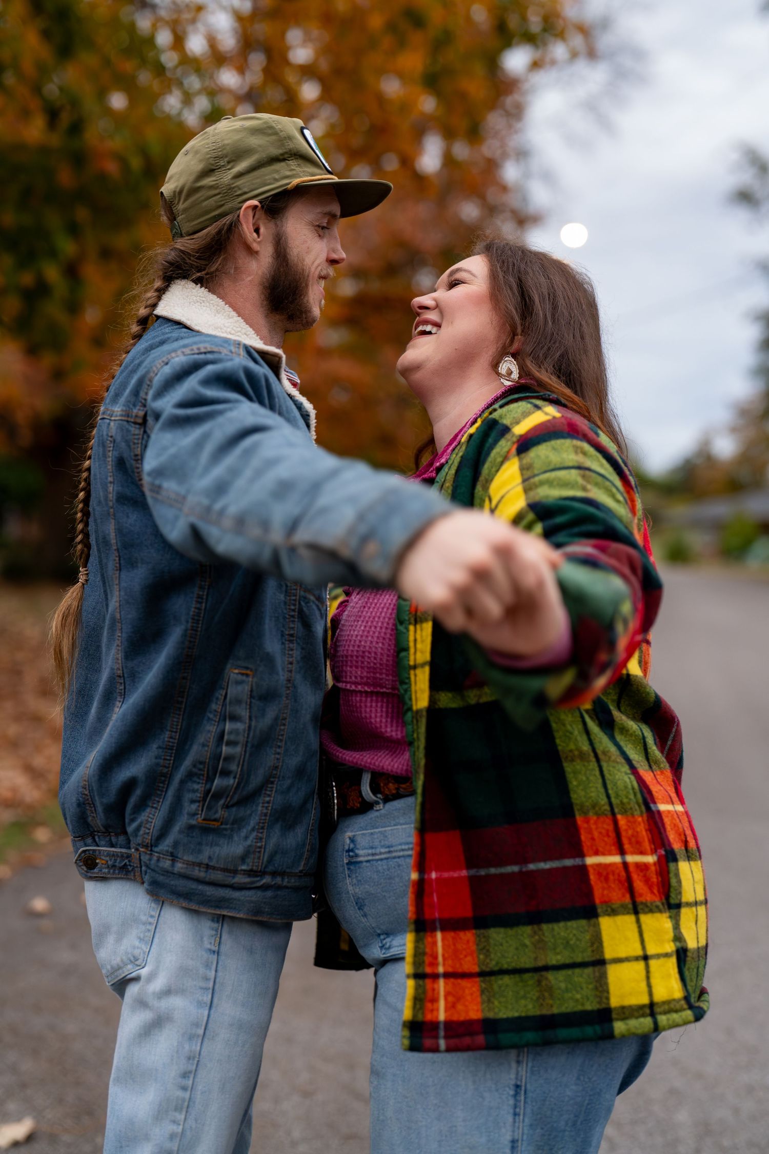 Couple sharing an affectionate moment during a colorful fall portrait session.