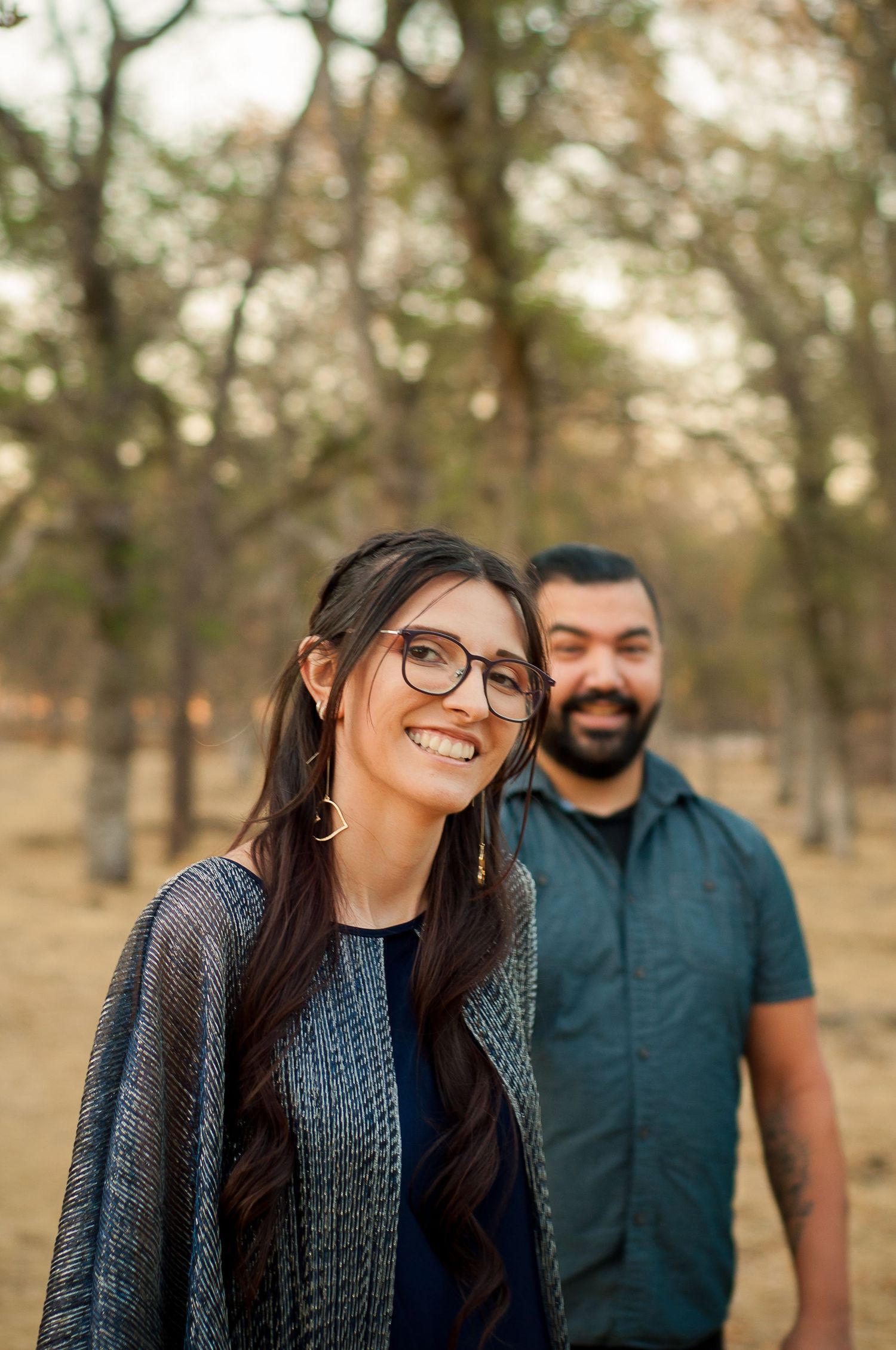 Couple smiling together during a relaxed outdoor portrait session.