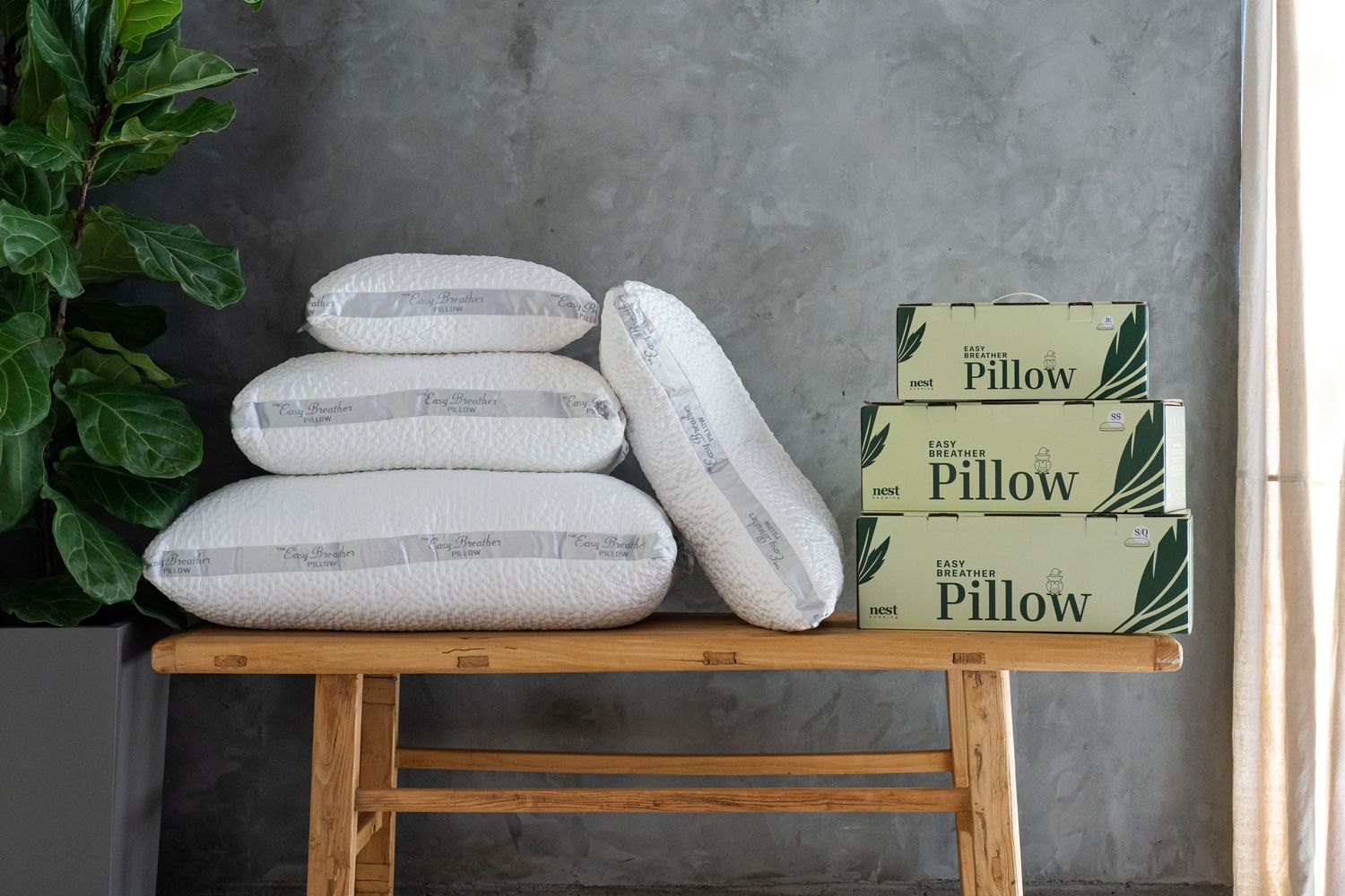 Product display of packaged pillows arranged on a wooden table.