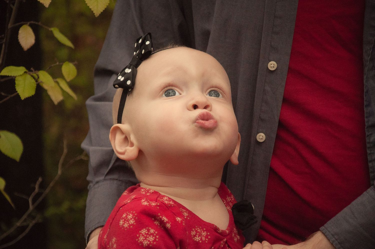 Close-up of a young child making a playful expression during a family portrait session.