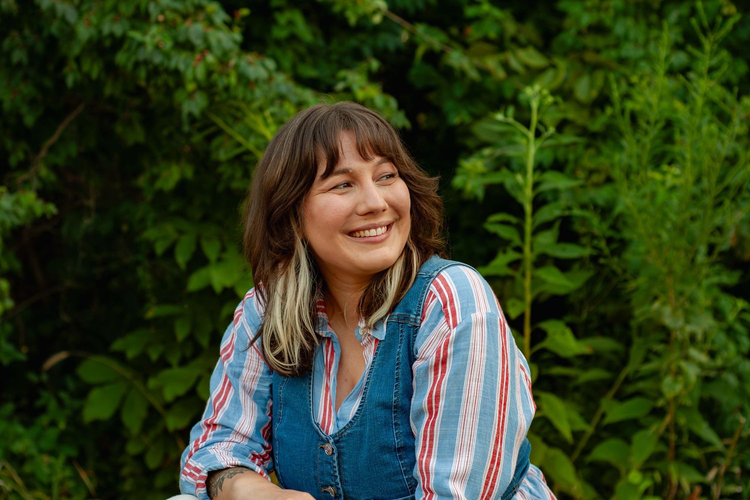 Marie Murray smiling during a relaxed outdoor professional portrait session.