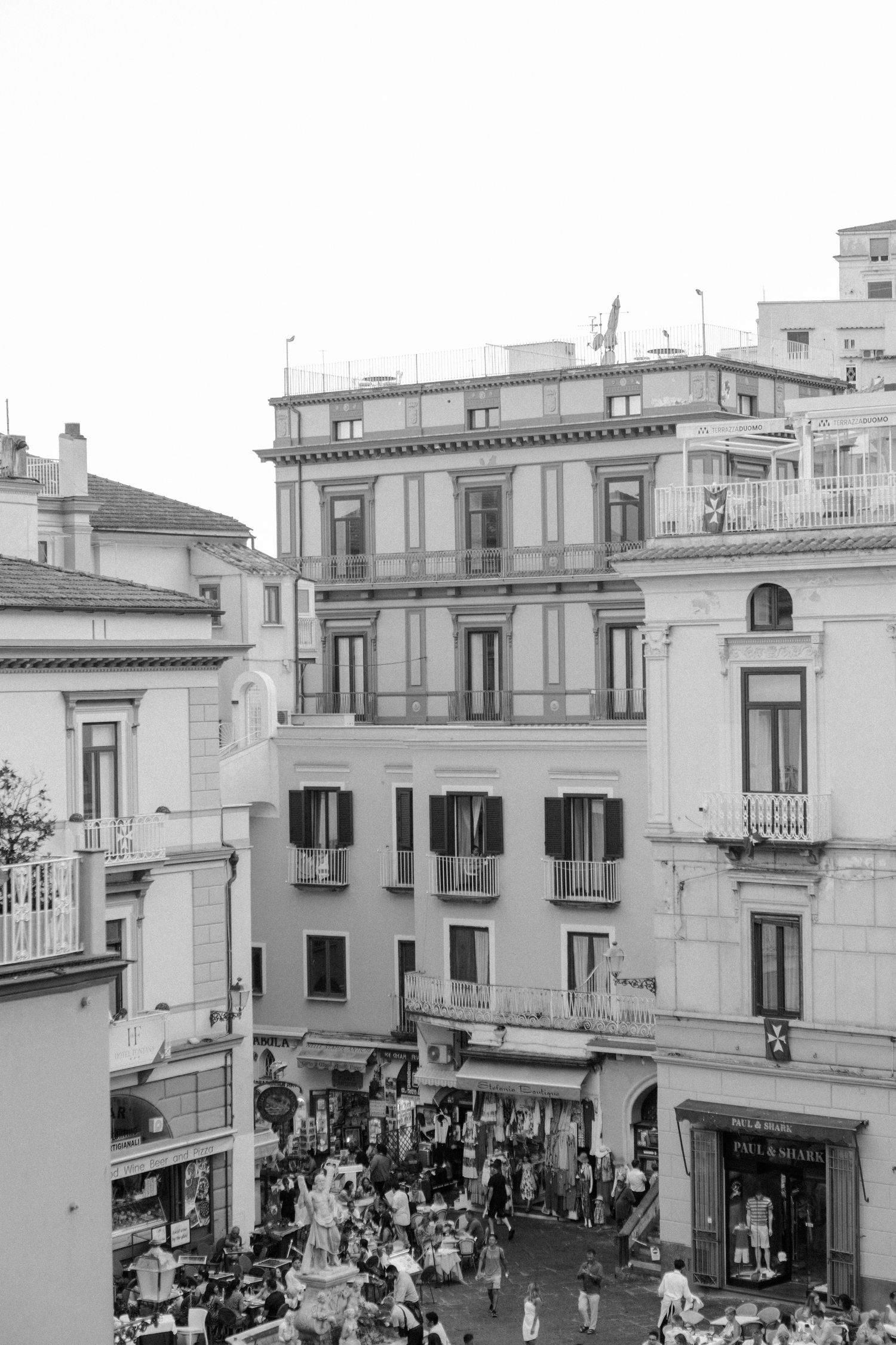 Black and white image of a busy street and architecture in Amalfi, Italy