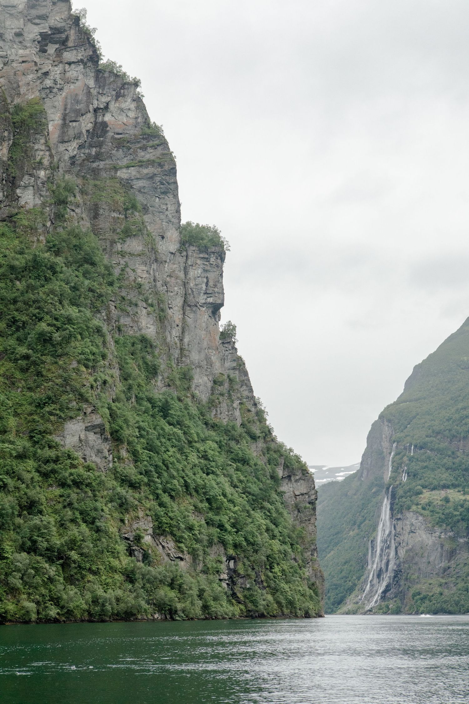 Landscape photography of a green mountain and waterfalls of a fjord in Norway