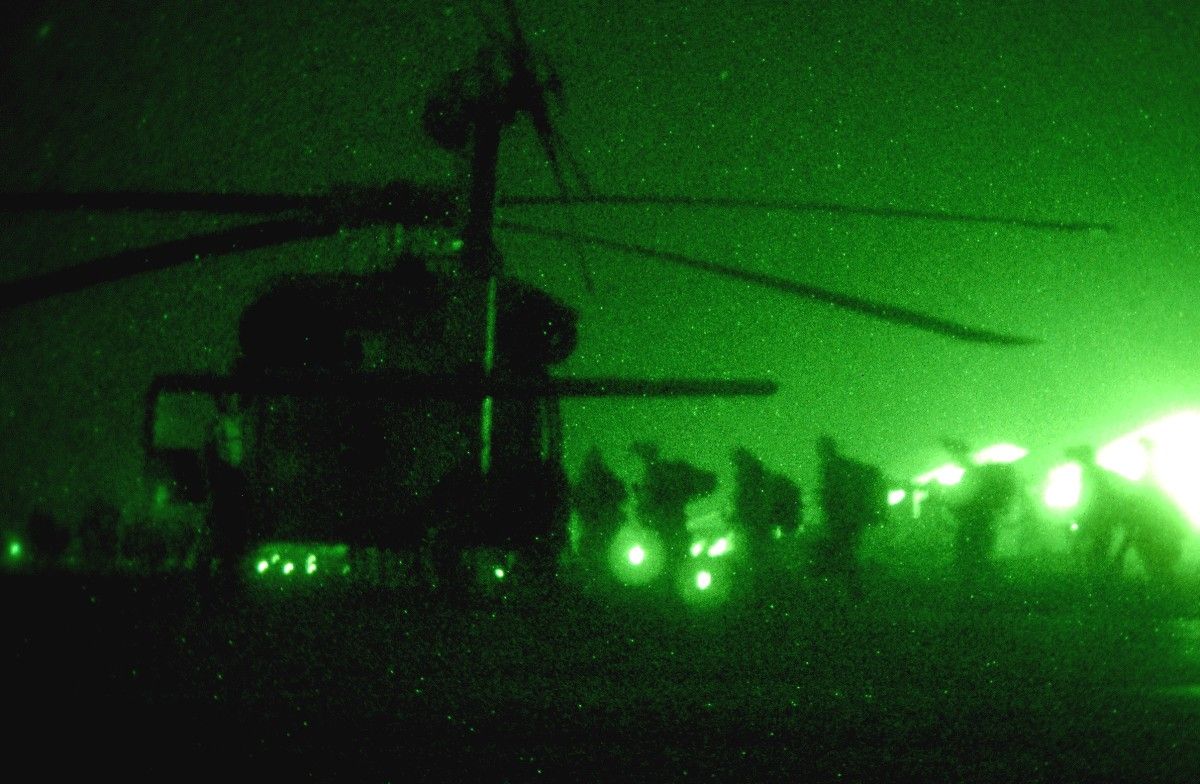 Night Vision of U.S. Military getting ready to load up on a helicopter before a mission