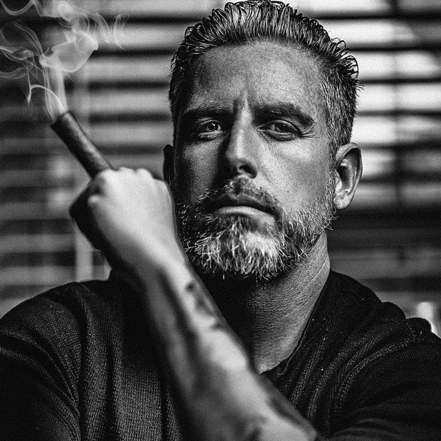 Self Portrait of a Man holding a cigar.