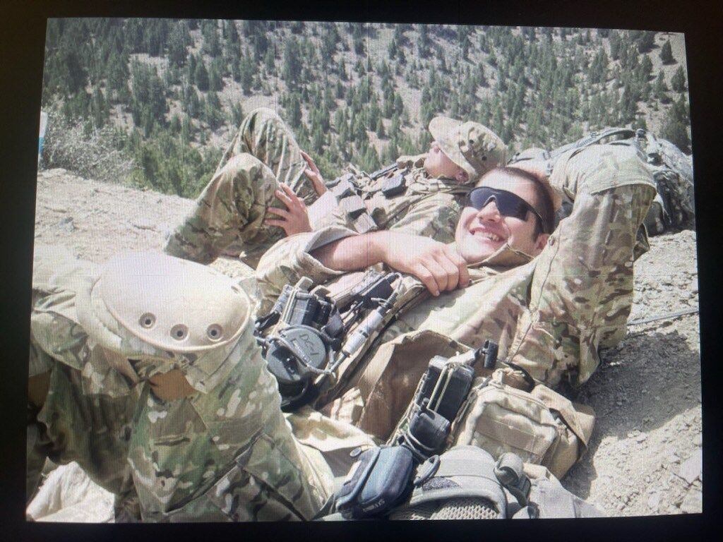 TACP in Afghanistan resting on the mountain side after a full day of patrolling.