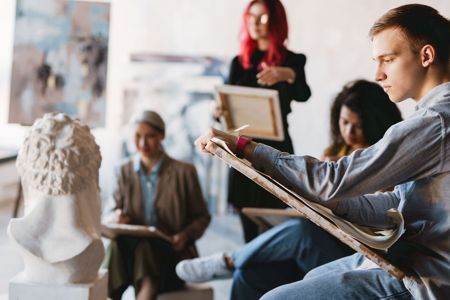 Art class looking at a sculpture as a reference as the subject of the drawing.