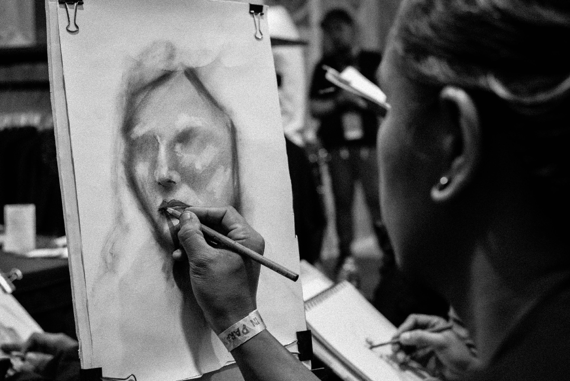 Artist creating a portrait piece of work.
